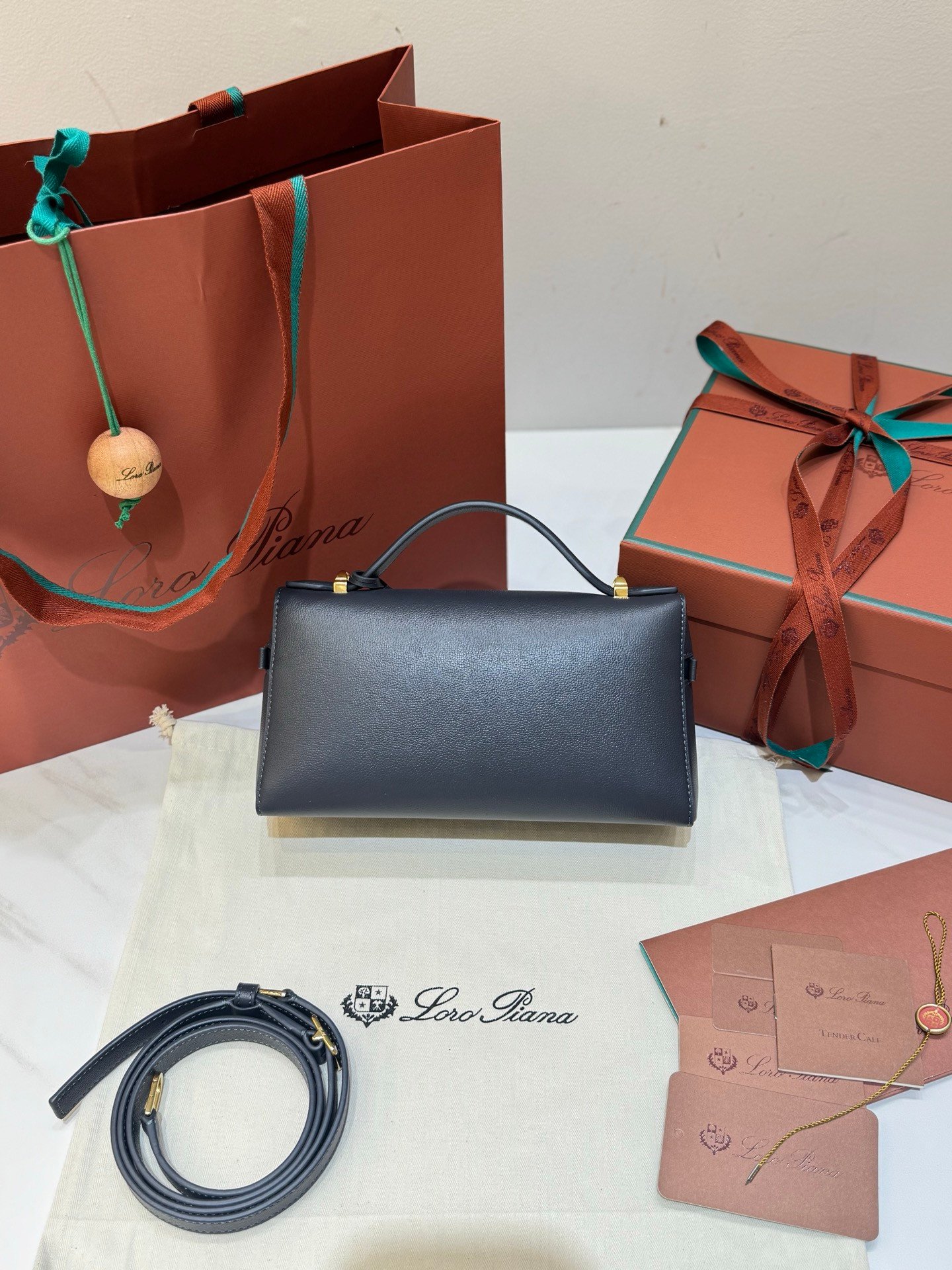 Loro Piana Extra Bag L23 Calfskin Leather Top Handle Bag 23cm Crossbody Handbag with Signature Padlock Charms and Adjustable Strap Loro Piana Extra Bag L23 Calfskin Leather Top Handle Bag 23cm Crossbody Handbag with Signature Padlock Charms and Adjustable Strap