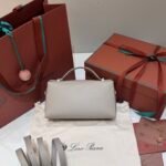 Loro Piana Extra Bag L23 Calfskin Leather Top Handle Bag 23cm Crossbody Handbag with Signature Padlock Charms and Adjustable Strap Loro Piana Extra Bag L23 Calfskin Leather Top Handle Bag 23cm Crossbody Handbag with Signature Padlock Charms and Adjustable Strap