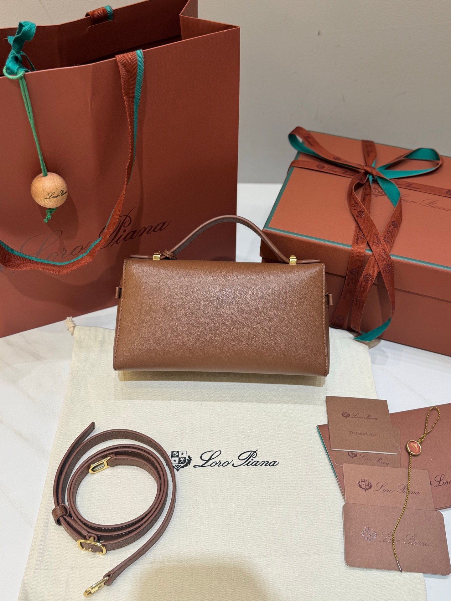 Loro Piana Extra Bag L23 Calfskin Leather Top Handle Bag 23cm Crossbody Handbag with Signature Padlock Charms and Adjustable Strap Loro Piana Extra Bag L23 Calfskin Leather Top Handle Bag 23cm Crossbody Handbag with Signature Padlock Charms and Adjustable Strap