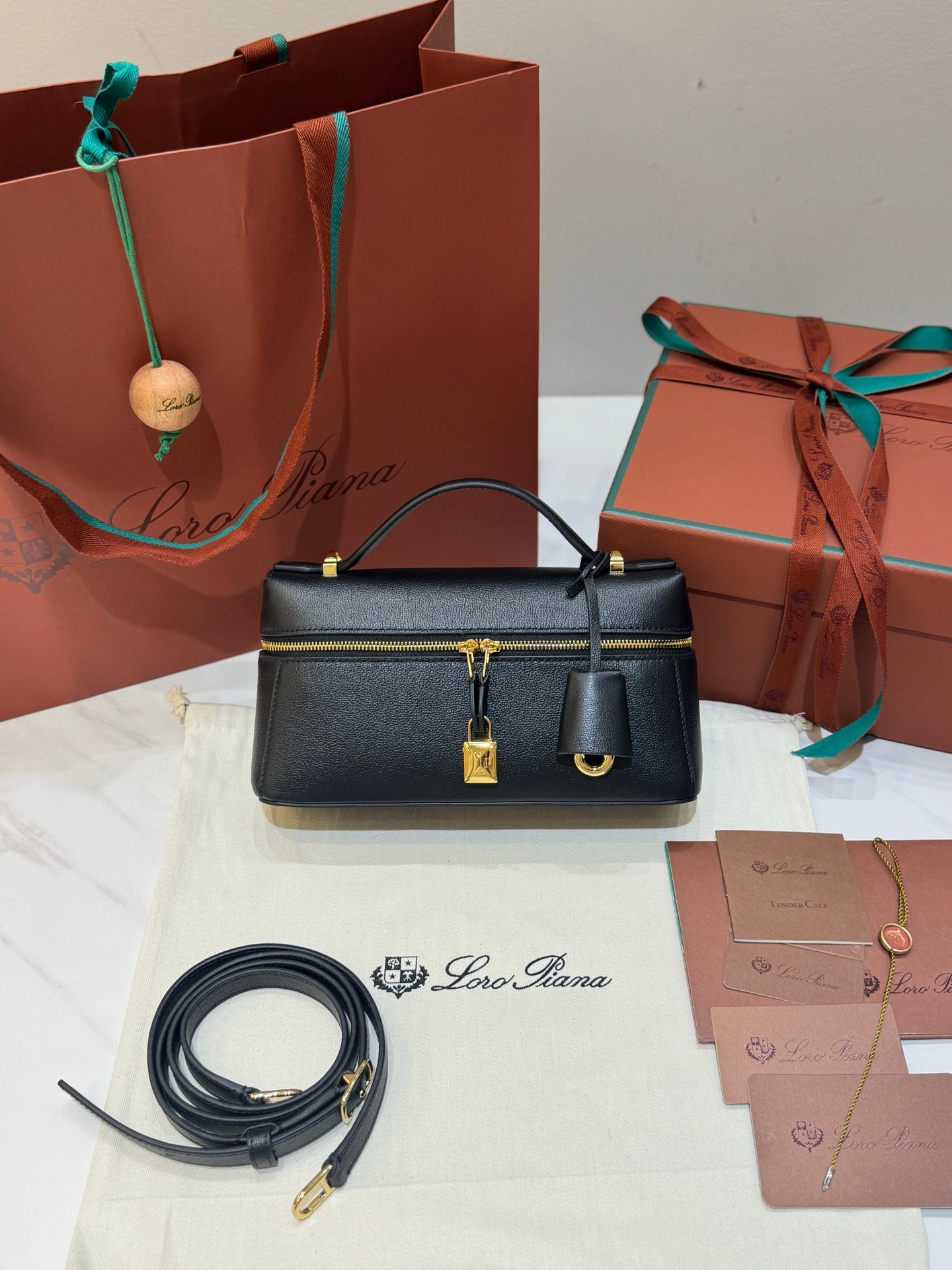 Loro Piana Extra Bag L23 Calfskin Leather Top Handle Bag 23cm Crossbody Handbag with Signature Padlock Charms and Adjustable Strap Loro Piana Extra Bag L23 Calfskin Leather Top Handle Bag 23cm Crossbody Handbag with Signature Padlock Charms and Adjustable Strap