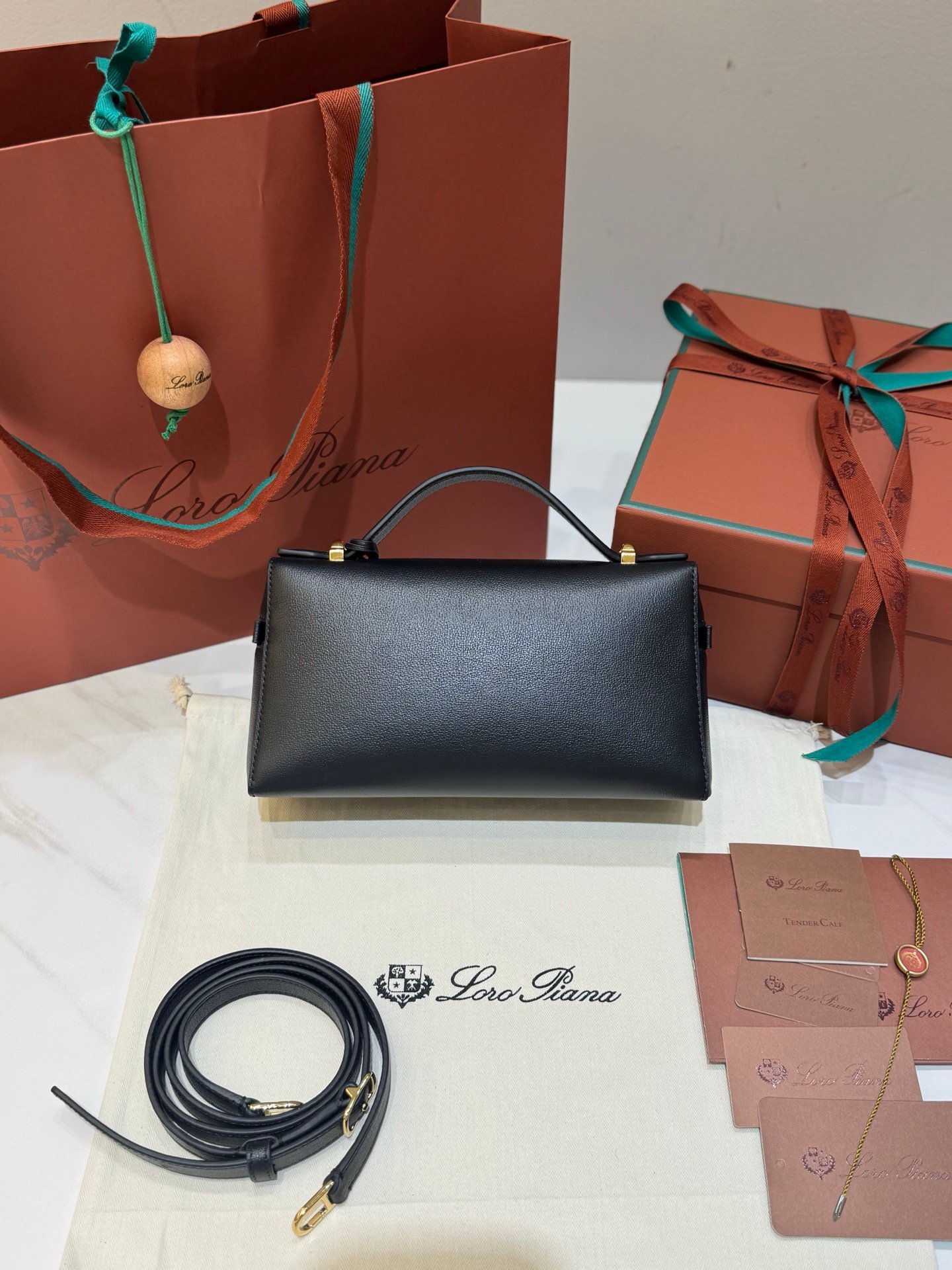 Loro Piana Extra Bag L23 Calfskin Leather Top Handle Bag 23cm Crossbody Handbag with Signature Padlock Charms and Adjustable Strap Loro Piana Extra Bag L23 Calfskin Leather Top Handle Bag 23cm Crossbody Handbag with Signature Padlock Charms and Adjustable Strap