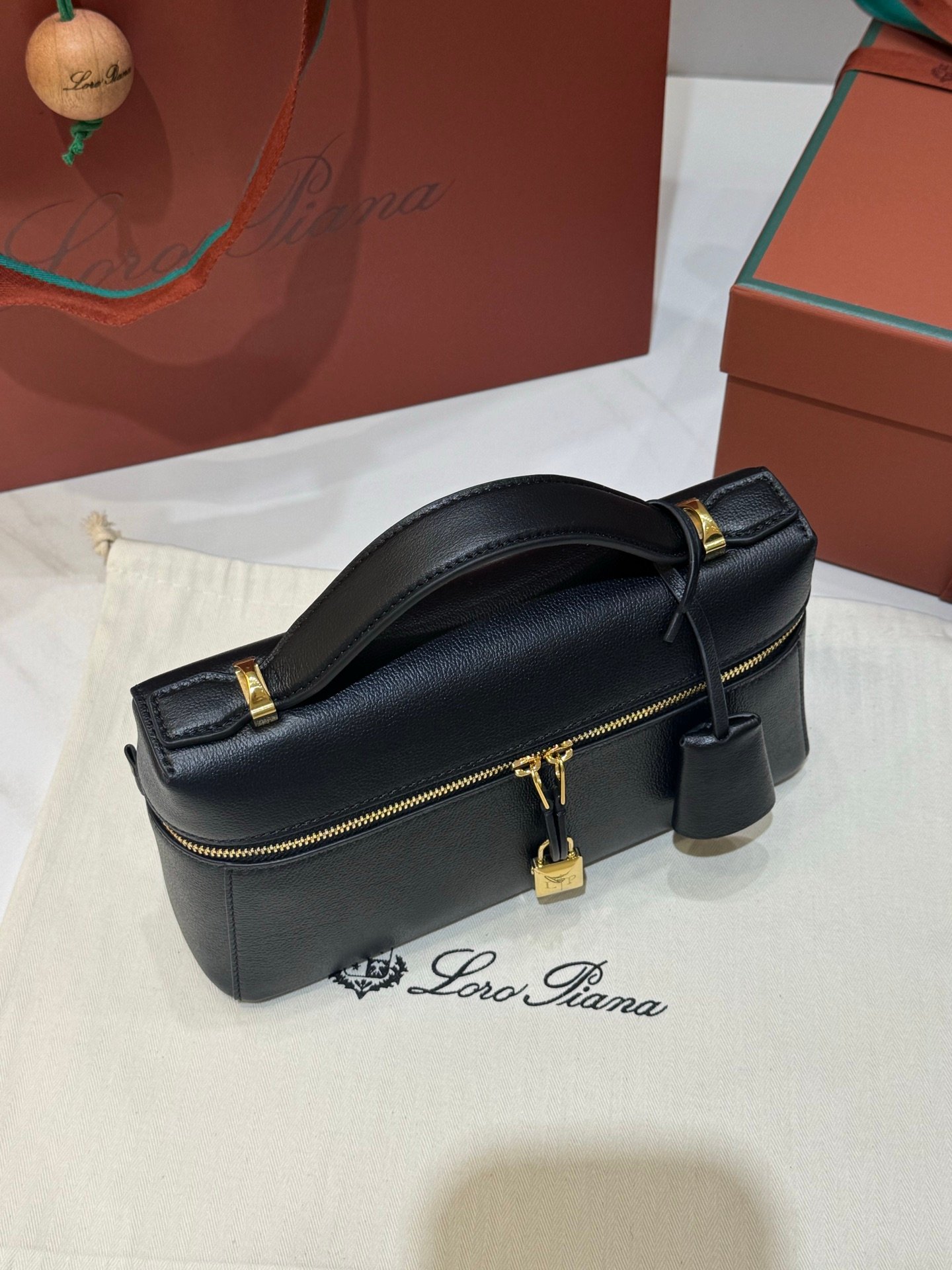 Loro Piana Extra Bag L23 Calfskin Leather Top Handle Bag 23cm Crossbody Handbag with Signature Padlock Charms and Adjustable Strap Loro Piana Extra Bag L23 Calfskin Leather Top Handle Bag 23cm Crossbody Handbag with Signature Padlock Charms and Adjustable Strap