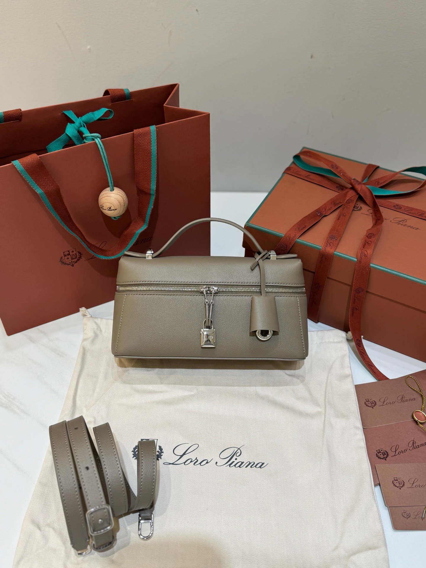 Loro Piana Extra Bag L23 Calfskin Leather Top Handle Bag 23cm Crossbody Handbag with Signature Padlock Charms and Adjustable Strap Loro Piana Extra Bag L23 Calfskin Leather Top Handle Bag 23cm Crossbody Handbag with Signature Padlock Charms and Adjustable Strap