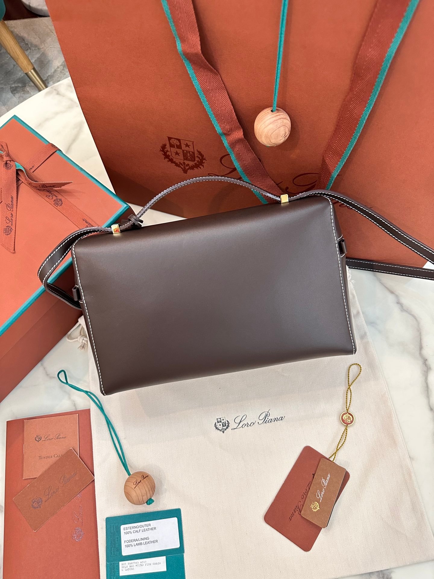 Loro Piana L27 Extra Bag 27 Minimalist Quiet Luxury Leather Tote Bag Structured Calfskin Crossbody Bag with Signature Padlock Loro Piana L27 Extra Bag 27 Minimalist Quiet Luxury Leather Tote Bag Structured Calfskin Crossbody Bag with Signature Padlock