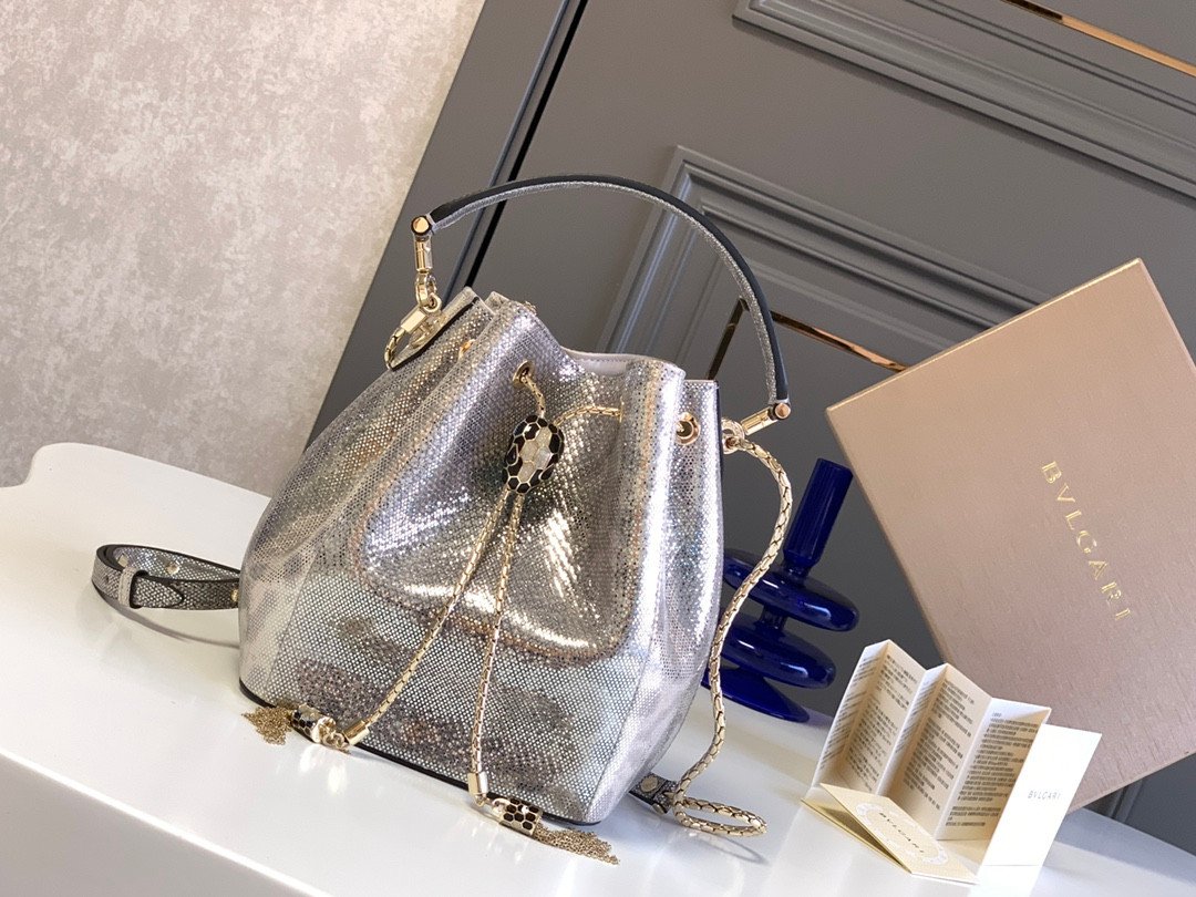 BVLGARI Serpenti Forever Metallic Karung Leather Bucket Bag 16cm Exotic Drawstring Crossbody and Top Handle Handbag with Signature Snakehead Closure BVLGARI Serpenti Forever Metallic Karung Leather Bucket Bag 16cm Exotic Drawstring Crossbody and Top Handle Handbag with Signature Snakehead Closure