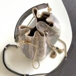 BVLGARI Serpenti Forever Metallic Karung Leather Bucket Bag 16cm Exotic Drawstring Crossbody and Top Handle Handbag with Signature Snakehead Closure BVLGARI Serpenti Forever Metallic Karung Leather Bucket Bag 16cm Exotic Drawstring Crossbody and Top Handle Handbag with Signature Snakehead Closure