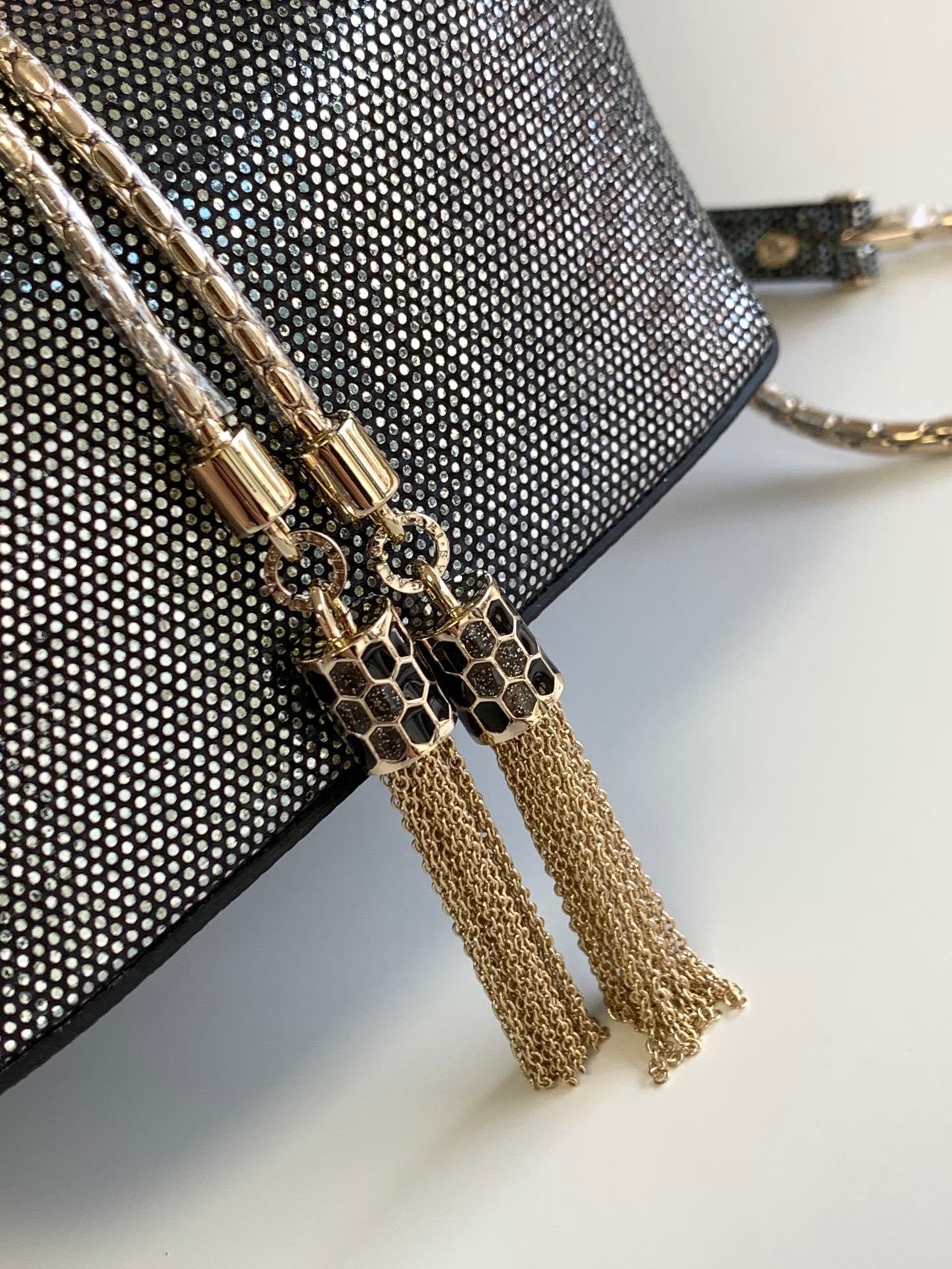 BVLGARI Serpenti Forever Metallic Karung Leather Bucket Bag 16cm Exotic Drawstring Crossbody and Top Handle Handbag with Signature Snakehead Closure BVLGARI Serpenti Forever Metallic Karung Leather Bucket Bag 16cm Exotic Drawstring Crossbody and Top Handle Handbag with Signature Snakehead Closure
